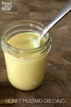 honey mustard dressing in a glass jar with a spoon