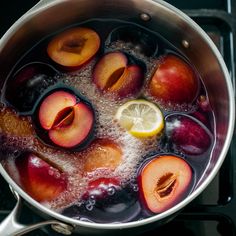 plums, lemon and water in a pan on the stove