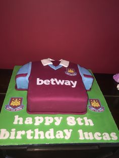 a birthday cake that is shaped like a soccer jersey