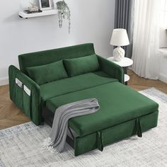 a living room with a green couch and white rug