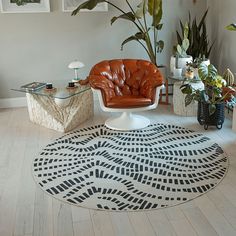 a living room filled with furniture and plants