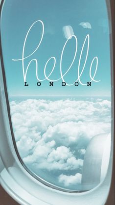 an airplane window with the word hello london written on it's side and clouds below