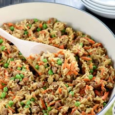 a white bowl filled with rice and peas