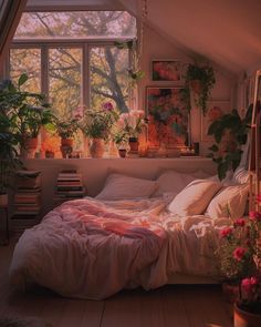 a bedroom with lots of potted plants in the window sill and bedding