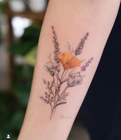 a woman's arm with a flower tattoo on it