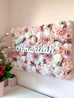 a flower wall with the word amardah written on it