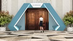 a woman standing in front of an entrance to a building with blue and white accents