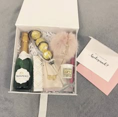 an open box containing champagne and other items