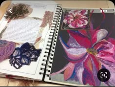 an open notebook with some art work on it and a page in the book that has been altered to look like flowers