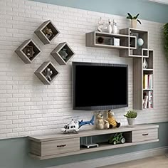 there is a television on the wall in this living room with white brick walls and shelving