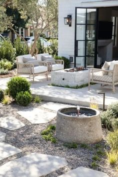 an outdoor patio with seating and fire pit