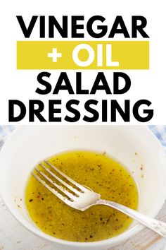 a white bowl filled with salad dressing next to a fork