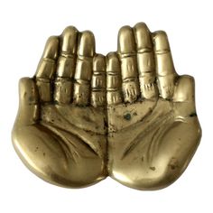 two gold hands that are holding each other