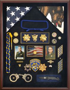 a shadow box is filled with badges, medals and other items that are on display