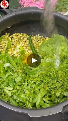 a pot filled with lots of green vegetables and steam rising out of the top one