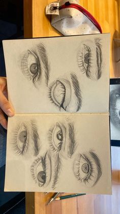 two drawings of different eyes with pencil on paper