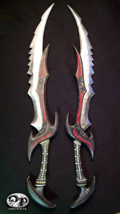 two large knives with red and white handles