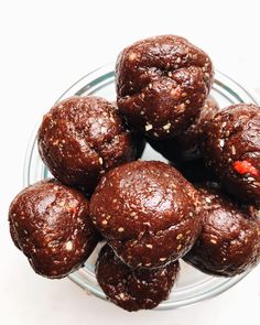 a glass bowl filled with chocolate muffins on top of a table