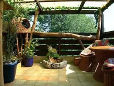 an outdoor area with wicker furniture and plants