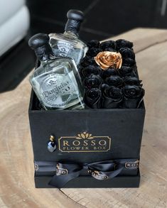 a black box with roses and bottles in it