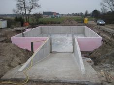 an unfinished pool being built in the middle of a field