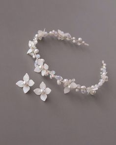 a white flower headband with pearls and crystals