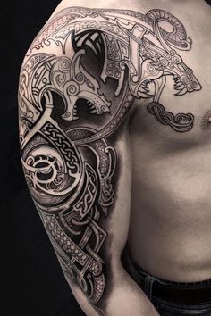 a man's chest with an intricate tattoo design on his left arm and shoulder