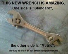 a wrench is sitting on top of a pillow with the words, this new wrench is amazing one side is standard