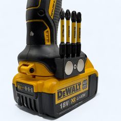 a drill and some screwdrivers sitting on top of each other