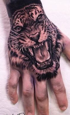 a hand with a tiger tattoo on it's palm and an open mouth in the middle