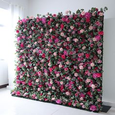 a wall covered in pink and red flowers