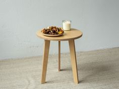 a small table with a plate of food on it and a glass of milk next to it