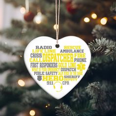 a white heart ornament hanging from a christmas tree with words written on it