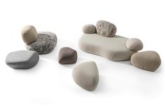 several different colored rocks sitting on top of each other in front of a white background