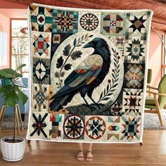 a woman standing in front of a quilt with a bird on it's back