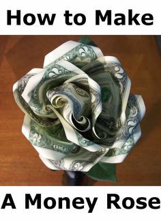 a flower made out of money sitting on top of a wooden table with the words how to make a money rose