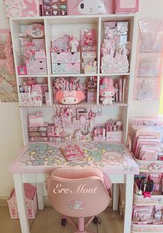 a pink desk with hello kitty decorations on it and shelves full of other items in the background