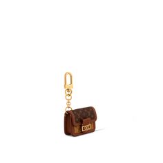 a small brown purse with a gold chain hanging from it's front pocket, on a white background