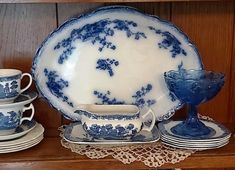 a blue and white china set on a shelf