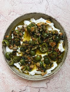 a bowl filled with green olives and whipped cream