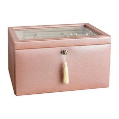 a pink jewelry box with a tassel hanging from the front and bottom lid,