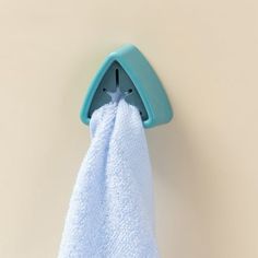 a blue towel hanging from a hook on a wall with a star shaped object in it