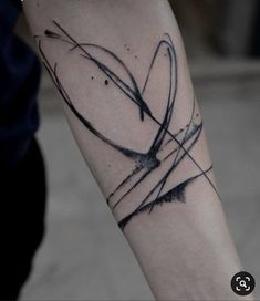 a black and white tattoo design on the left arm with lines coming out of it