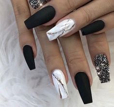 black and white stiled nails with glitter accents