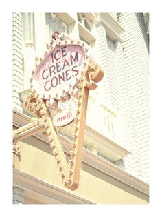 an ice cream cone sign on the side of a building