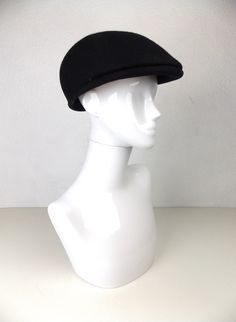 a white mannequin head wearing a black hat