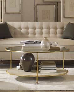 a living room with a couch, coffee table and books