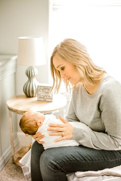 a woman holding a baby in her lap