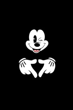 the mickey mouse logo is black and white with two hands on it's chest