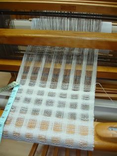 a close up of a weaving machine with yarn on it